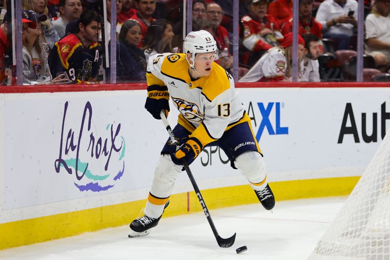 Nov 7, 2024; Sunrise, Florida, USA; Nashville Predators center Juuso Parssinen (13) moves the puck against the Florida Panthers during the third period at Amerant Bank Arena. Mandatory Credit: Sam Navarro-Imagn Images