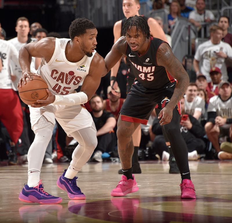 CLEVELAND, OH - APRIL 23: Donovan Mitchell #45 of the Cleveland Cavaliers is defended by Davion Mitchell #45 of the Miami Heat during Round One Game Two of the 2025 NBA Playoffs on April 23, 2025 at Rocket Mortgage FieldHouse in Cleveland, Ohio. NOTE TO USER: User expressly acknowledges and agrees that, by downloading and/or using this Photograph, user is consenting to the terms and conditions of the Getty Images License Agreement. Mandatory Copyright Notice: Copyright 2025 NBAE (Photo by David Liam Kyle/NBAE via Getty Images)