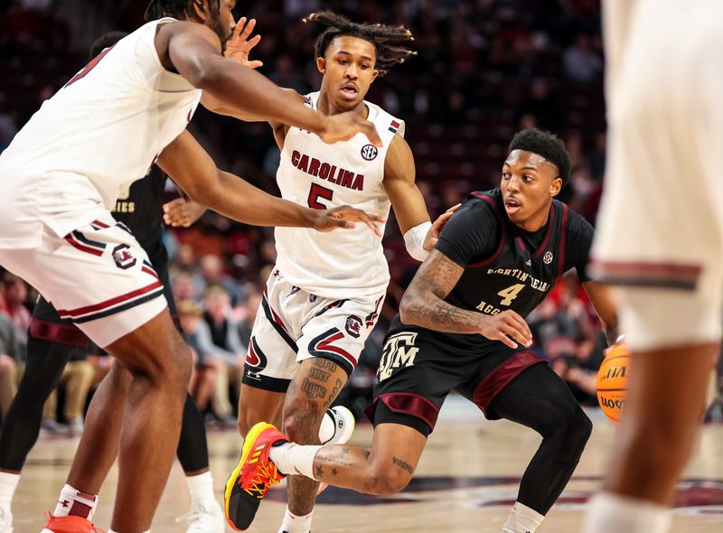 Jan 14, 2023; Columbia, South Carolina, USA; South Carolina Gamecocks center Tre-Vaughn Minott (4) drives against South Carolina Gamecocks forward Josh Gray (33) and guard Meechie Johnson (5) in the second half at Colonial Life Arena. Mandatory Credit: Jeff Blake-USA TODAY Sports