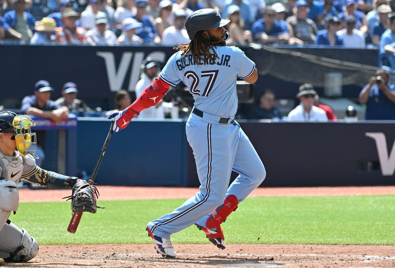 Jun 1, 2023; Toronto, Ontario, CAN; Toronto Blue Jays designated hitter Vladimir Guerrero Jr. (27) hits a single against the Milwaukee Brewers in the eighth inning at Rogers Centre. Mandatory Credit: Dan Hamilton-USA TODAY Sports