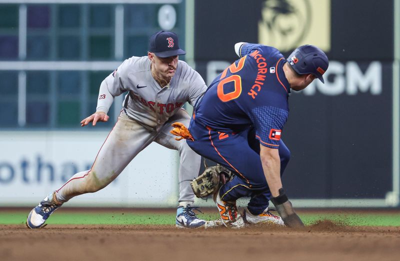 Aug 19, 2024; Houston, Texas, USA; Houston Astros left fielder Chas McCormick (20) is safe with a stolen base as Boston Red Sox second baseman Romy Gonzalez (23) attempts to apply a tag during the eighth inning at Minute Maid Park. Mandatory Credit: Troy Taormina-USA TODAY Sports