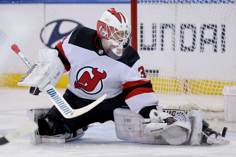 Mar 11, 2024; New York, New York, USA; New Jersey Devils goaltender Kaapo Kahkonen (31) makes a save against the New York Rangers during the third period at Madison Square Garden. Mandatory Credit: Brad Penner-USA TODAY Sports