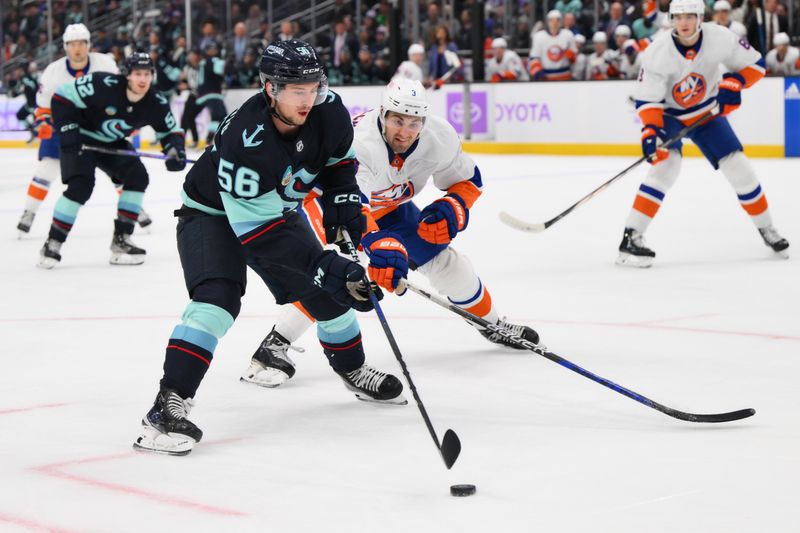 Nov 16, 2023; Seattle, Washington, USA; Seattle Kraken right wing Kailer Yamamoto (56) and New York Islanders defenseman Adam Pelech (3) play the puck during the first period at Climate Pledge Arena. Mandatory Credit: Steven Bisig-USA TODAY Sports