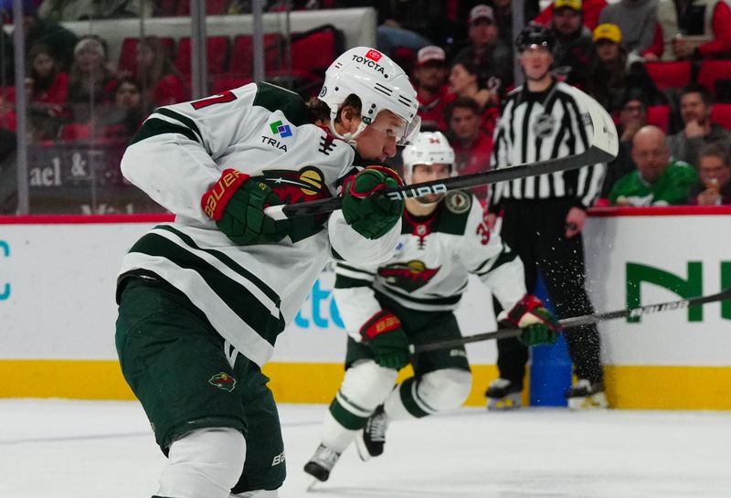 Jan 21, 2024; Raleigh, North Carolina, USA;  Minnesota Wild left wing Kirill Kaprizov (97) scores a goal against the Carolina Hurricanes during the second period at PNC Arena. Mandatory Credit: James Guillory-USA TODAY Sports