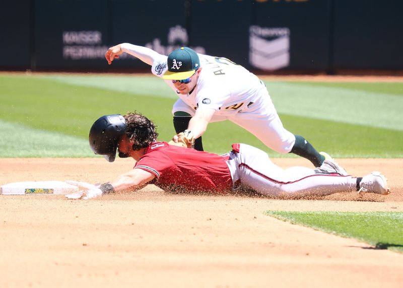 May 17, 2023; Oakland, California, USA; Arizona Diamondbacks center fielder Dominic Fletcher (8) safely reaches second base against Oakland Athletics shortstop Nick Allen (2) during the fifth inning at Oakland-Alameda County Coliseum. Mandatory Credit: Kelley L Cox-USA TODAY Sports