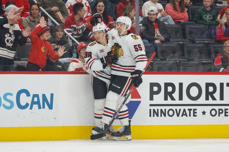 Nov 9, 2025; Detroit, Michigan, USA;  Chicago Blackhawks center Connor Bedard (98) celebrates with defenseman Artyom Levshunov (55) after scoring a goal in the first period at Little Caesars Arena. Mandatory Credit: Brian Bradshaw Sevald-Imagn Images