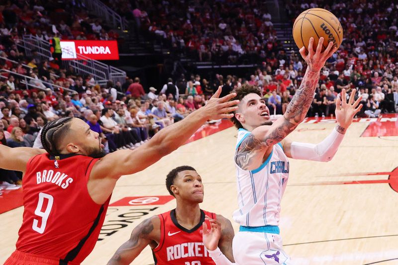 HOUSTON, TEXAS - OCTOBER 23: LaMelo Ball #1 of the Charlotte Hornets shoots over Dillon Brooks #9 of the Houston Rockets during the second half at Toyota Center on October 23, 2024 in Houston, Texas.  NOTE TO USER: User expressly acknowledges and agrees that, by downloading and or using this photograph, User is consenting to the terms and conditions of the Getty Images License Agreement. (Photo by Alex Slitz/Getty Images)