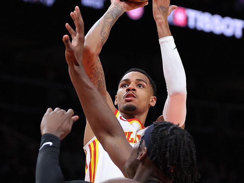 ATLANTA, GEORGIA - FEBRUARY 27:  Dejounte Murray #5 of the Atlanta Hawks attempts a shot against Taylor Hendricks #0 of the Utah Jazz during the second quarter at State Farm Arena on February 27, 2024 in Atlanta, Georgia.  NOTE TO USER: User expressly acknowledges and agrees that, by downloading and/or using this photograph, user is consenting to the terms and conditions of the Getty Images License Agreement.  (Photo by Kevin C. Cox/Getty Images)