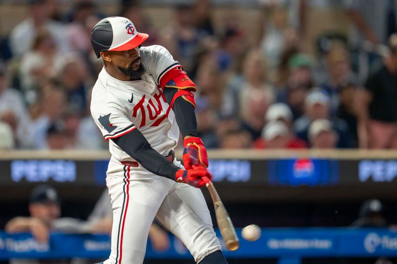 Sep 15, 2025; Minneapolis, Minnesota, USA; Minnesota Twins center fielder Byron Buxton (21) hits a single against the New York Yankees in the fifth inning at Target Field. Mandatory Credit: Jesse Johnson-Imagn Images