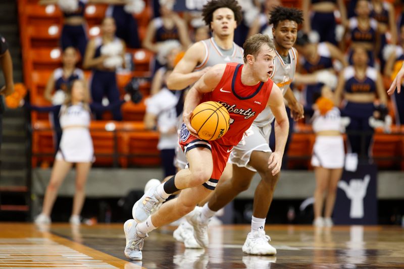 Feb 3, 2024; El Paso, Texas, USA; Liberty University Flames guard Kaden Metheny (3) dribbles the ball against the UTEP Miners defense in the first half at Don Haskins Center. Mandatory Credit: Ivan Pierre Aguirre-USA TODAY Sports