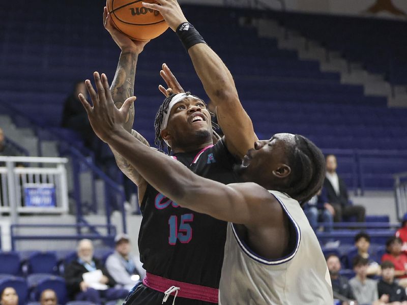 Jan 24, 2024; Houston, Texas, USA; Florida Atlantic Owls guard Alijah Martin (15) drives to the basket as Rice Owls forward Sam Alajiki (0) defends during the first half at Tudor Fieldhouse. Mandatory Credit: Troy Taormina-USA TODAY Sports