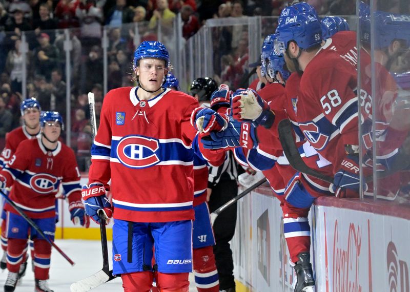 Oct 14, 2024; Montreal, Quebec, CAN; Montreal Canadiens defenseman Kaiden Guhle (21) celebrates with teammates after scoring a goal against the Pittsburgh Penguins during the first period at the Bell Centre. Mandatory Credit: Eric Bolte-Imagn Images