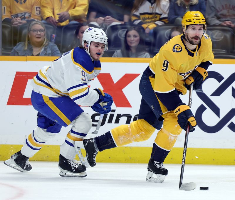 Mar 7, 2024; Nashville, Tennessee, USA; Nashville Predators left wing Filip Forsberg (9) moves the puck past Buffalo Sabres left wing Zach Benson (9) at Bridgestone Arena. Mandatory Credit: Alan Poizner-USA TODAY Sports