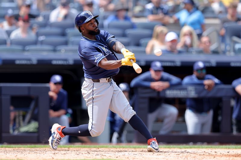 Jul 20, 2024; Bronx, New York, USA; Tampa Bay Rays left fielder Randy Arozarena (56) hits a two run home run against the New York Yankees during the seventh inning at Yankee Stadium. Mandatory Credit: Brad Penner-USA TODAY Sports