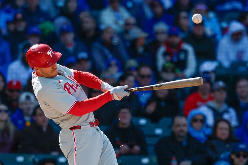 Apr 26, 2025; Chicago, Illinois, USA; Philadelphia Phillies catcher J.T. Realmuto (10) breaks his bat on a single against the Chicago Cubs during the fourth inning at Wrigley Field. Mandatory Credit: Kamil Krzaczynski-Imagn Images