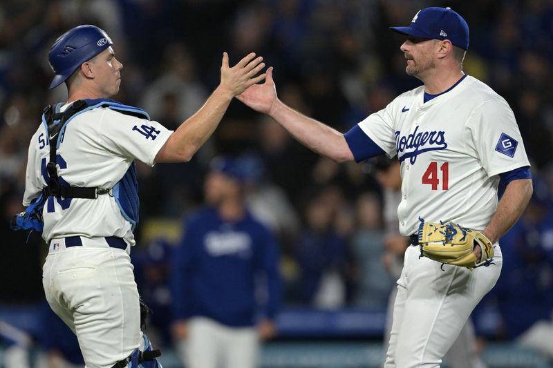 May 20, 2024; Los Angeles, California, USA;  Los Angeles Dodgers catcher Will Smith (16) shakes hands with relief pitcher Daniel Hudson (41) after the final out of the ninth inning against the Arizona Diamondbacks at Dodger Stadium. Mandatory Credit: Jayne Kamin-Oncea-USA TODAY Sports
