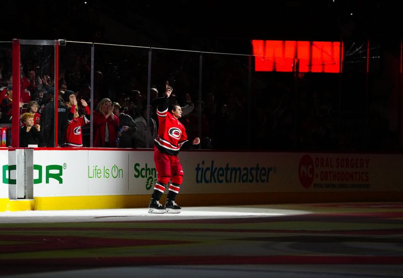 Jan 11, 2024; Raleigh, North Carolina, USA; Carolina Hurricanes center Seth Jarvis (24) celebrates the win against the Anaheim Ducks at PNC Arena. Mandatory Credit: James Guillory-USA TODAY Sports