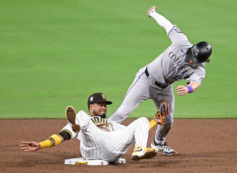Sep 11, 2025; San Diego, California, USA; Colorado Rockies right fielder Mickey Moniak (22) steals second as San Diego Padres second baseman Luis Arraez (4) tries to make the tag during the sixth inning at Petco Park. Mandatory Credit: Denis Poroy-Imagn Images