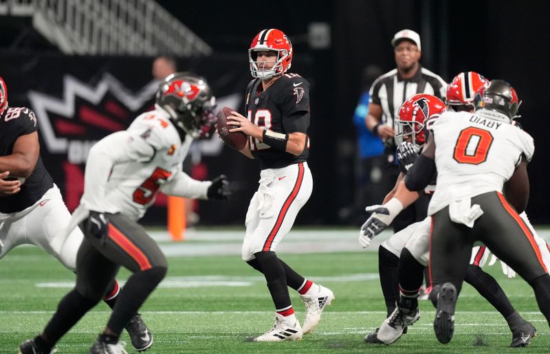 Atlanta Falcons quarterback Kirk Cousins (18) looks to pass against the Tampa Bay Buccaneers during the first half of an NFL football game Thursday, Oct. 3, 2024, in Atlanta. (AP Photo/John Bazemore)
