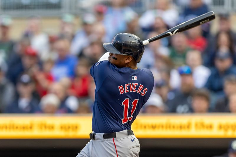 May 3, 2024; Minneapolis, Minnesota, USA; Boston Red Sox third baseman Rafael Devers (11) hits a double against the Minnesota Twins in the first inning at Target Field. Mandatory Credit: Jesse Johnson-USA TODAY Sports