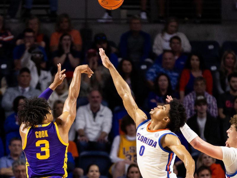 Feb 13, 2024; Gainesville, Florida, USA; Florida Gators guard Zyon Pullin (0) attempts to block a shot from LSU Tigers guard Jalen Cook (3) during the second half at Exactech Arena at the Stephen C. O'Connell Center. Mandatory Credit: Matt Pendleton-USA TODAY Sports