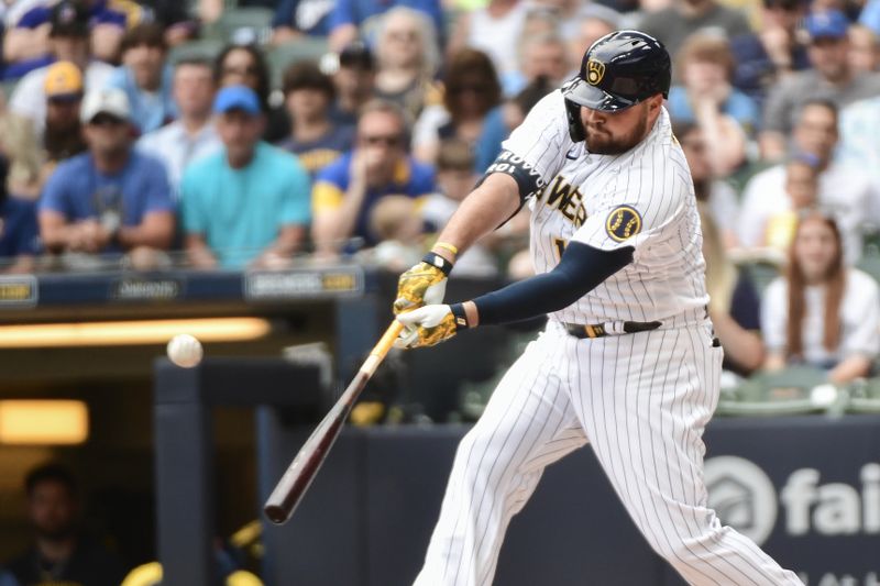 Jun 10, 2023; Milwaukee, Wisconsin, USA;  Milwaukee Brewers designated hitter Rowdy Tellez (11) hits a single against the Oakland Athletics in the first inning at American Family Field. Mandatory Credit: Benny Sieu-USA TODAY Sports