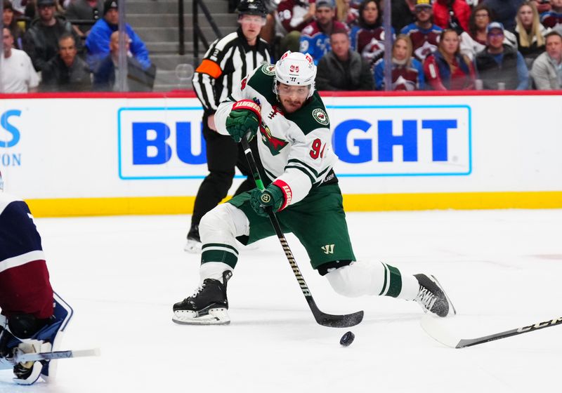 Feb 28, 2025; Denver, Colorado, USA; Minnesota Wild center Jakub Lauko (94) shoots the puck in the first period against the Colorado Avalanche at Ball Arena. Mandatory Credit: Ron Chenoy-Imagn Images