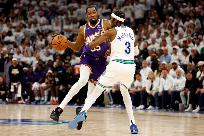 MINNEAPOLIS, MINNESOTA - APRIL 23: Kevin Durant #35 of the Phoenix Suns drives to the basket against Jaden McDaniels #3 of the Minnesota Timberwolves in the fourth quarter of game two of the Western Conference First Round Playoffs at Target Center on April 23, 2024 in Minneapolis, Minnesota. The Timberwolves defeated the Sun 105-93. NOTE TO USER: User expressly acknowledges and agrees that, by downloading and or using this photograph, User is consenting to the terms and conditions of the Getty Images License Agreement. (Photo by David Berding/Getty Images)