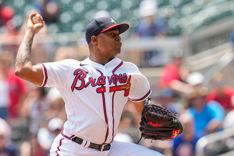 Jul 20, 2023; Cumberland, Georgia, USA; Atlanta Braves relief pitcher Raisel Iglesias (26) pitches against the Arizona Diamondbacks during the ninth inning at Truist Park. Mandatory Credit: Dale Zanine-USA TODAY Sports