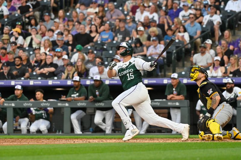 Jun 15, 2024; Denver, Colorado, USA; Colorado Rockies catcher Hunter Goodman (15) hits a double in the fourth inning against the Pittsburgh Pirates at Coors Field. Mandatory Credit: John Leyba-USA TODAY Sports