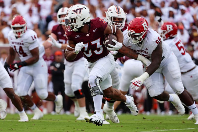 Sep 21, 2024; Blacksburg, Virginia, USA; Virginia Tech Hokies running back Bhayshul Tuten (33) runs the ball during the first quarter against the Rutgers Scarlet Knights at Lane Stadium. Mandatory Credit: Peter Casey-Imagn Images