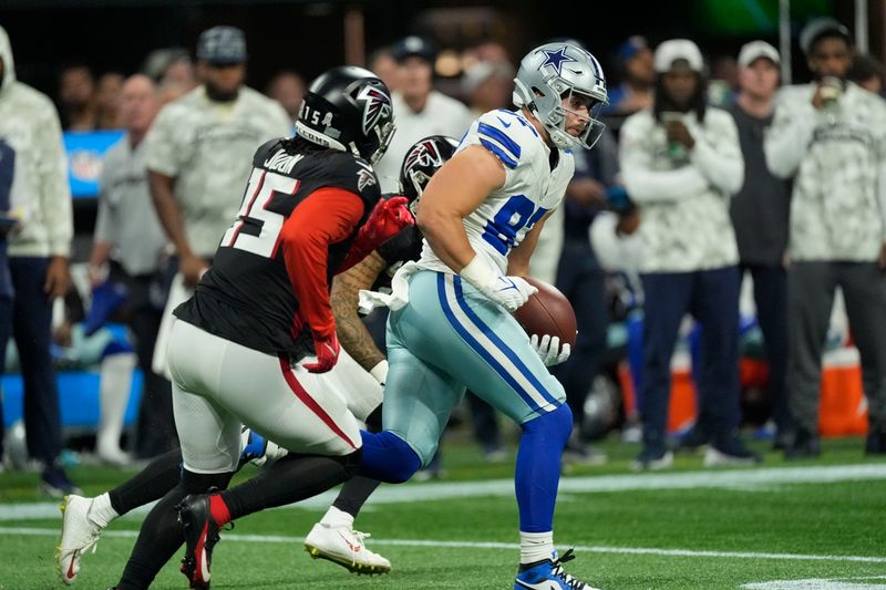 Dallas Cowboys tight end Jake Ferguson (87) carries during the first half of an NFL football game against the Atlanta Falcons, Sunday, Nov. 3, 2024, in Atlanta. (AP Photo/ John Bazemore)