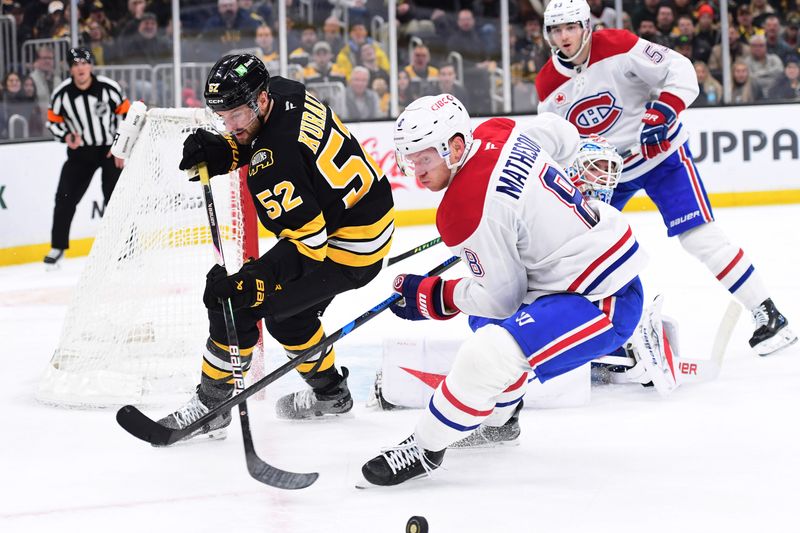 Dec 23, 2025; Boston, Massachusetts, USA; Boston Bruins center Sean Kuraly (52) and Montreal Canadiens defenseman Mike Matheson (8) battle for the puck during the first period at TD Garden. Mandatory Credit: Bob DeChiara-Imagn Images