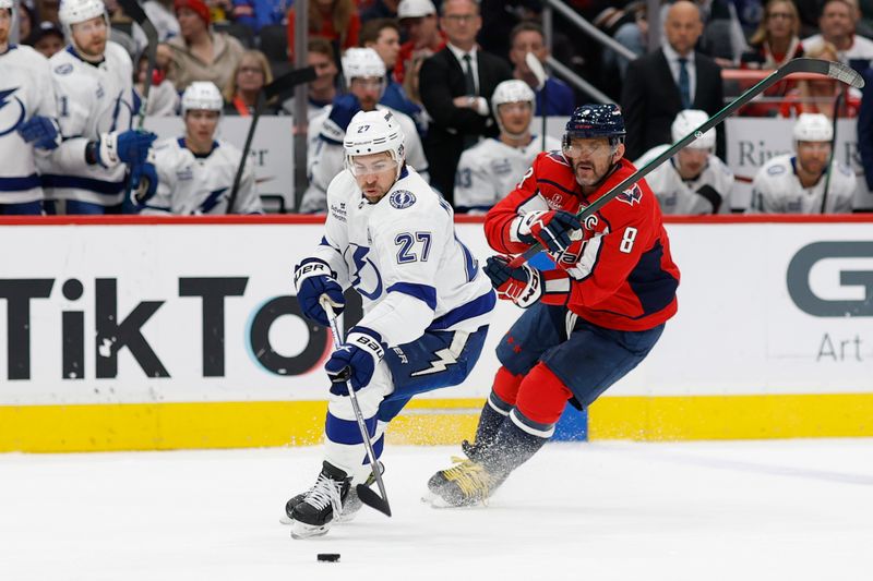 Mar 1, 2025; Washington, District of Columbia, USA; Tampa Bay Lightning defenseman Ryan McDonagh (27) skates with the puck as Washington Capitals left wing Alex Ovechkin (8) defends in the first period at Capital One Arena. Mandatory Credit: Geoff Burke-Imagn Images