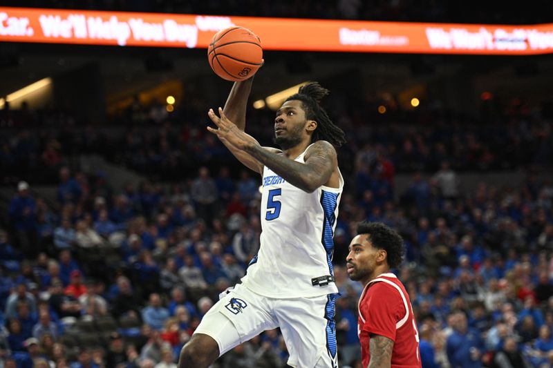 Nov 22, 2024; Omaha, Nebraska, USA;  Creighton Bluejays guard Jamiya Neal (5) scores against the Nebraska Cornhuskers during the second half at CHI Health Center Omaha. Mandatory Credit: Steven Branscombe-Imagn Images