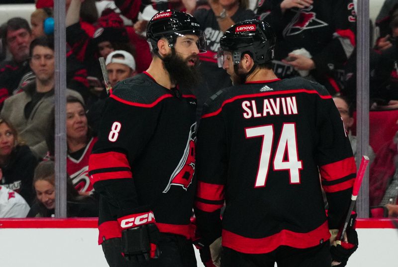 Apr 30, 2024; Raleigh, North Carolina, USA; Carolina Hurricanes defenseman Brent Burns (8) and defenseman Jaccob Slavin (74) talk against the New York Islanders during the first period in game five of the first round of the 2024 Stanley Cup Playoffs at PNC Arena. Mandatory Credit: James Guillory-USA TODAY Sports