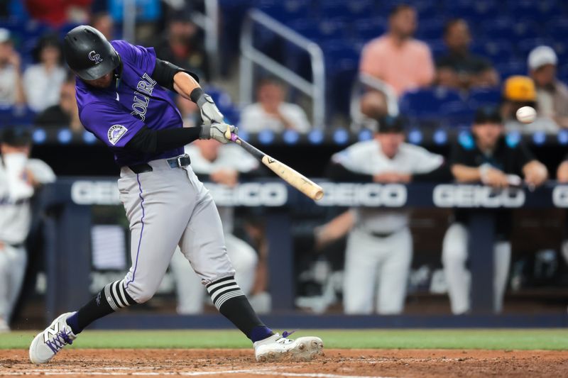 Jun 4, 2025; Miami, Florida, USA; Colorado Rockies right fielder Tyler Freeman (2) hits a double against the Miami Marlins during the fifth inning at loanDepot Park. Mandatory Credit: Sam Navarro-Imagn Images