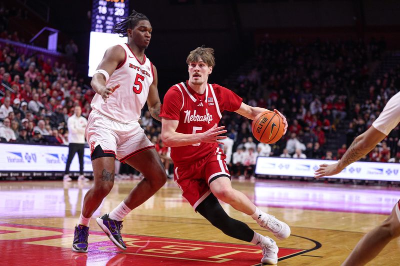 Feb 7, 2026; Piscataway, New Jersey, USA; Nebraska Cornhuskers forward Braden Frager (5) goes to the basket against Rutgers Scarlet Knights guard Darren Buchanan Jr. (5) during the first half at Jersey Mike's Arena. Mandatory Credit: Vincent Carchietta-Imagn Images