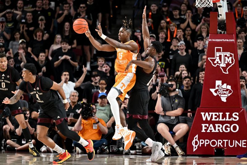 Feb 21, 2023; College Station, Texas, USA;  Tennessee Volunteers guard Jahmai Mashack (15) looks to pass the ball against Texas A&M Aggies forward Henry Coleman III (15) during the second half at Reed Arena. Mandatory Credit: Maria Lysaker-USA TODAY Sports