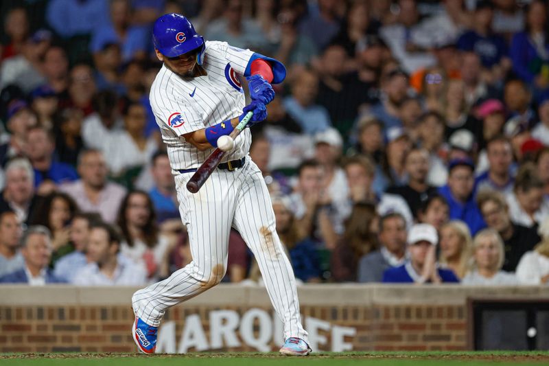 Sep 19, 2024; Chicago, Illinois, USA; Chicago Cubs third baseman Isaac Paredes (17) hits an RBI-sacrifice fly against the Washington Nationals during the fifth inning at Wrigley Field. Mandatory Credit: Kamil Krzaczynski-Imagn Images