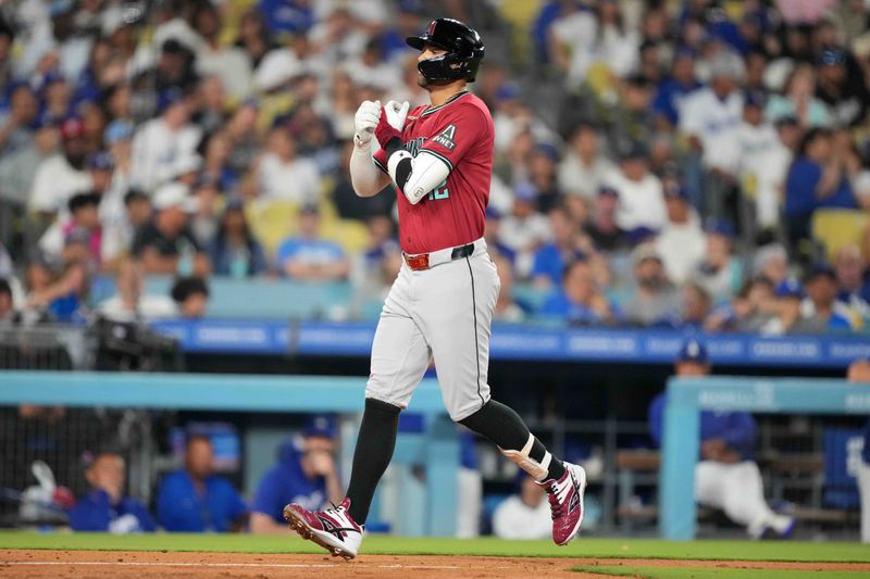 Jul 3, 2024; Los Angeles, California, USA; Arizona Diamondbacks left fielder Lourdes Gurriel Jr. (12) celebrates after hitting a two-run home run in the sixth inning against the Los Angeles Dodgers at Dodger Stadium. Mandatory Credit: Kirby Lee-USA TODAY Sports