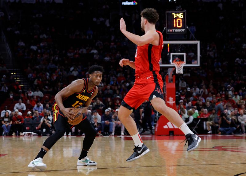 HOUSTON, TEXAS - DECEMBER 20: Alperen Sengun #28 of the Houston Rockets defends De'Andre Hunter #12 of the Atlanta Hawks during the first half at Toyota Center on December 20, 2023 in Houston, Texas. User expressly acknowledges and agrees that, by downloading and or using this photograph, User is consenting to the terms and conditions of the Getty Images License Agreement.?  (Photo by Carmen Mandato/Getty Images)