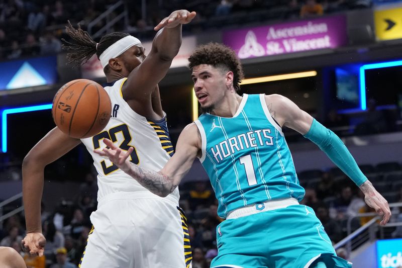 INDIANAPOLIS, INDIANA - OCTOBER 17: LaMelo Ball #1 of the Charlotte Hornets passes the ball while being guarded by Myles Turner #33 of the Indiana Pacers in the second quarter during a preseason game at Gainbridge Fieldhouse on October 17, 2024 in Indianapolis, Indiana. NOTE TO USER: User expressly acknowledges and agrees that, by downloading and or using this photograph, User is consenting to the terms and conditions of the Getty Images License Agreement. (Photo by Dylan Buell/Getty Images)