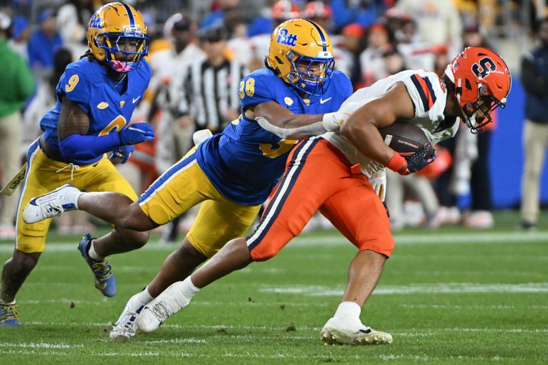 Oct 24, 2024; Pittsburgh, Pennsylvania, USA; Pittsburgh Panthers linebacker Keye Thompson (38) tackles Syracuse Orange tight end Oronde Gadsden II (19) during the second quarter  at Acrisure Stadium. Mandatory Credit: Barry Reeger-Imagn Images