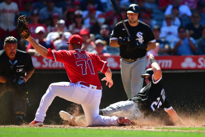 Jun 29, 2023; Anaheim, California, USA; Chicago White Sox first baseman Andrew Vaughn (25) scores a run ahead of Los Angeles Angels relief pitcher Jacob Webb (71) during the ninth inning at Angel Stadium. Mandatory Credit: Gary A. Vasquez-USA TODAY Sports