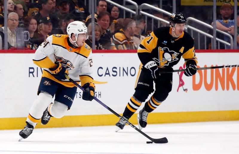 Apr 15, 2024; Pittsburgh, Pennsylvania, USA;  Nashville Predators defenseman Spencer Stastney (24) moves the puck against the Pittsburgh Penguins during the third period at PPG Paints Arena. The Penguins won 4-2. Mandatory Credit: Charles LeClaire-USA TODAY Sports