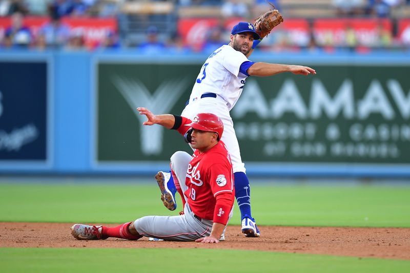 Jul 29, 2023; Los Angeles, California, USA; Cincinnati Reds first baseman Joey Votto (19) reaches second against Los Angeles Dodgers second baseman Chris Taylor (3) during the second inning at Dodger Stadium. Mandatory Credit: Gary A. Vasquez-USA TODAY Sports