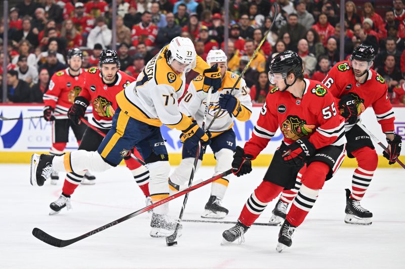 Apr 12, 2024; Chicago, Illinois, USA; Nashville Predators forward Luke Evangelista (77) attempts to shoot the puck while being defended by Chicago Blackhawks defenseman Kevin Korchinski (55) in the first period at United Center. Mandatory Credit: Jamie Sabau-USA TODAY Sports