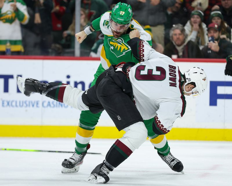 Jan 13, 2024; Saint Paul, Minnesota, USA; Minnesota Wild left wing Marcus Foligno (17) and Arizona Coyotes defenseman Josh Brown (3) fight during the third period at Xcel Energy Center. Mandatory Credit: Matt Krohn-USA TODAY Sports