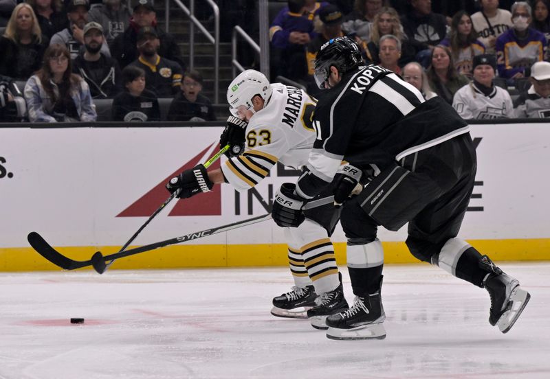 Oct 21, 2023; Los Angeles, California, USA; Boston Bruins left wing Brad Marchand (63) controls the puck against Los Angeles Kings center Anze Kopitar (11) during the third period at Crypto.com Arena. Mandatory Credit: Alex Gallardo-USA TODAY Sports